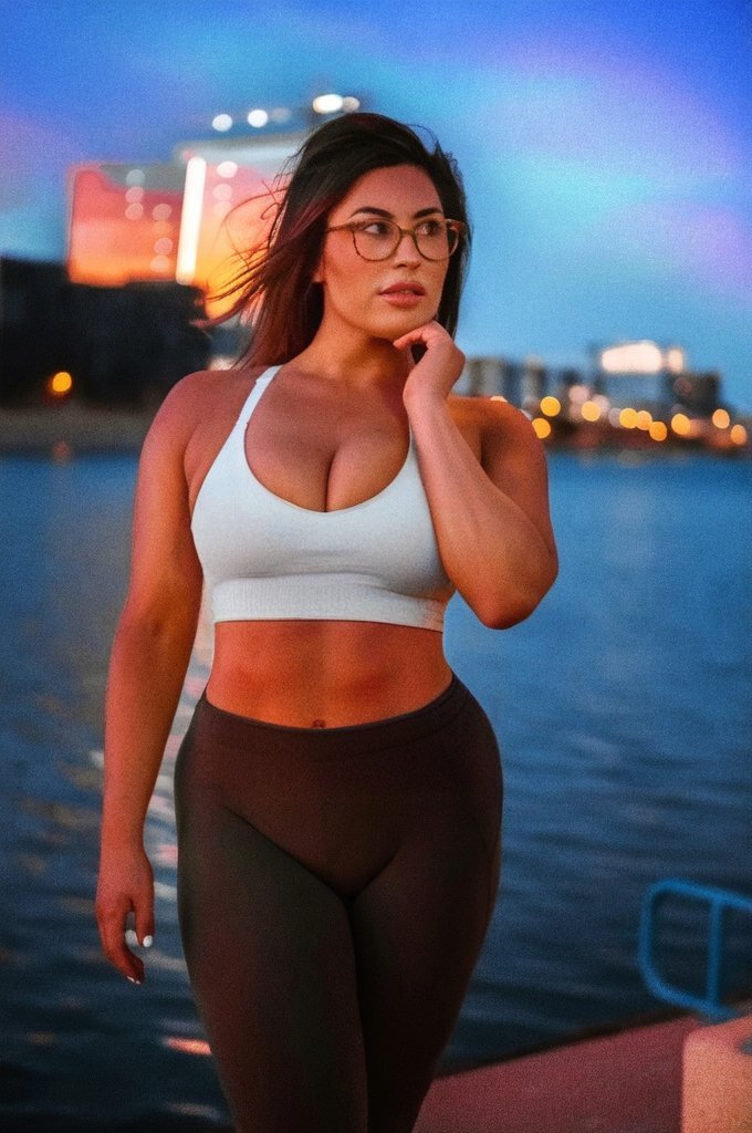 After: Before and after AI preview of a flatter, toned stomach on a woman in a white sports bra, made in Buldy